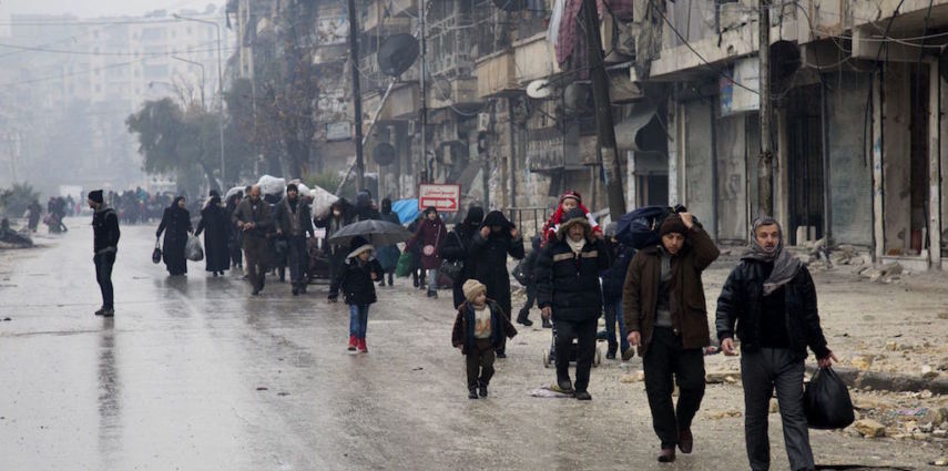 <p>Syrians leave a rebel-held area of Aleppo towards the government-held side on December 13, 2016 during an operation by Syrian government forces to retake the embattled city.<br />
UN chief Ban Ki-moon expressed alarm over reports of atrocities against civilians Monday, as the battle for Aleppo entered its final phase with Syrian government forces on the verge of retaking rebel-held areas of the city.</p>
<p> / AFP / KARAM AL-MASRI        (Photo credit should read KARAM AL-MASRI/AFP/Getty Images)</p>
